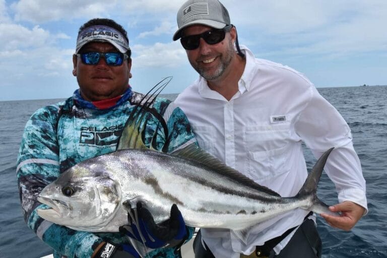 A fisherman holding a large roosterfish Guanacaste Fishing