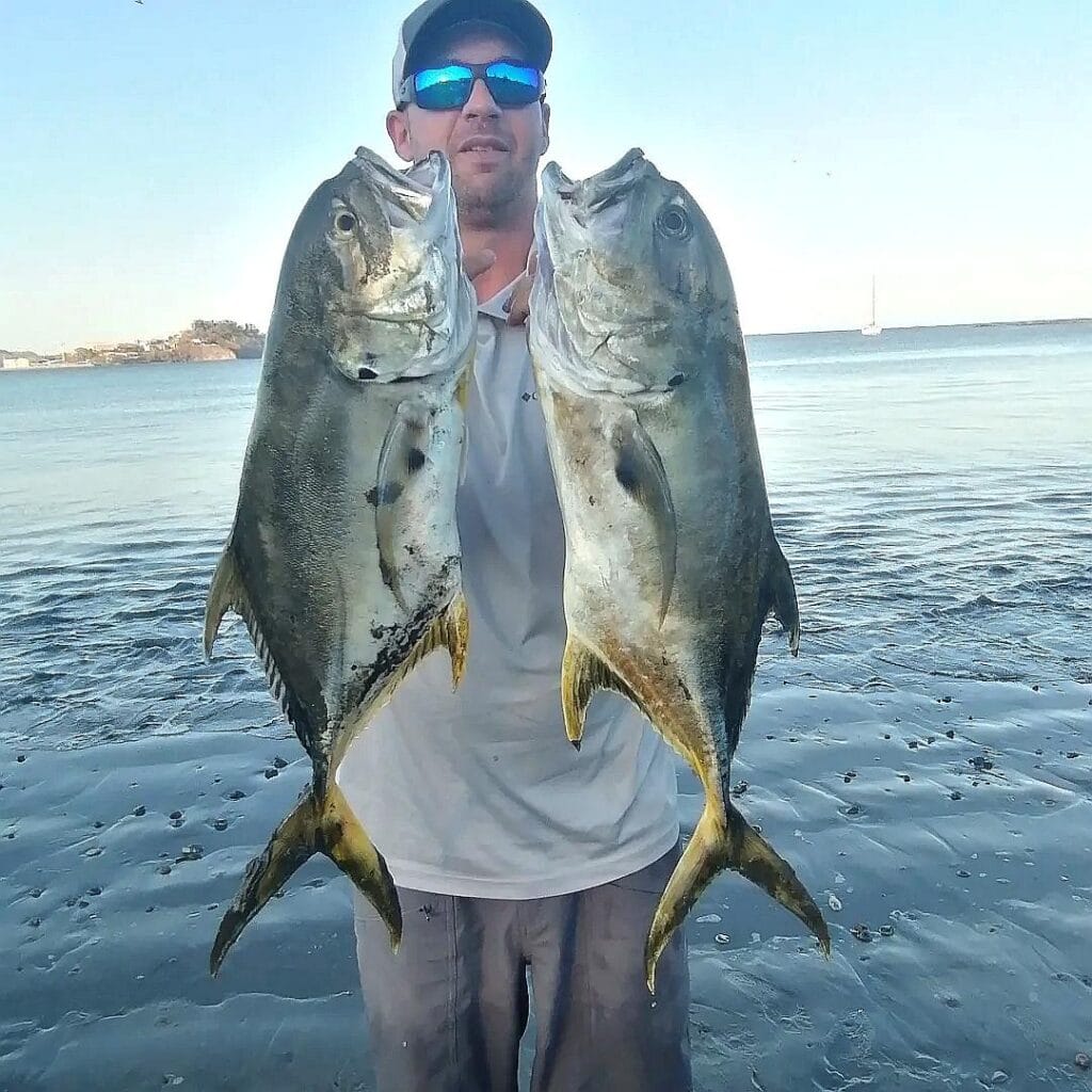 The owner at Fish Potrero holding up his catches after a Surf Fishing Costa Rica tour
