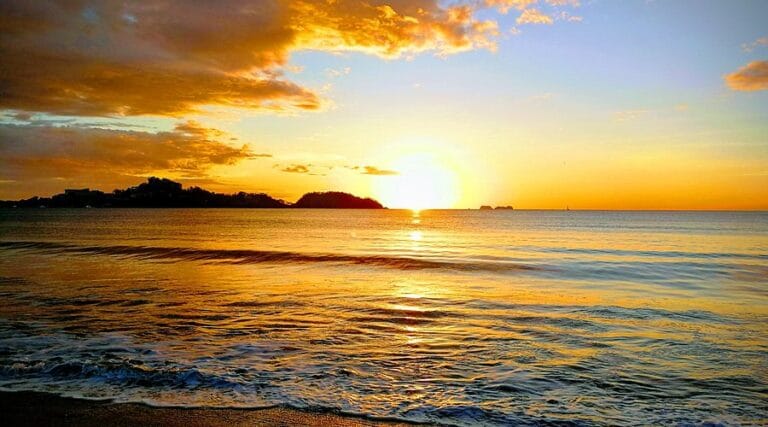Vivid orange sunset at Playa Flamingo, views you can see on a Catamaran sunset cruise with Fish Potrero.
