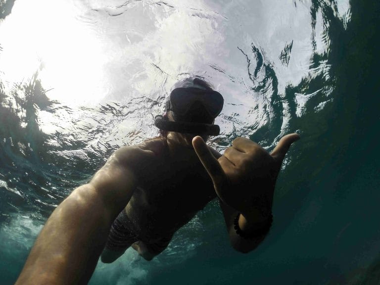 Happy client snorkeling right under the surface of the Pacific Ocean in Guanacaste