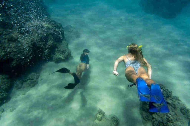 Girls snorkeling in Playa Flamingo searching for fish