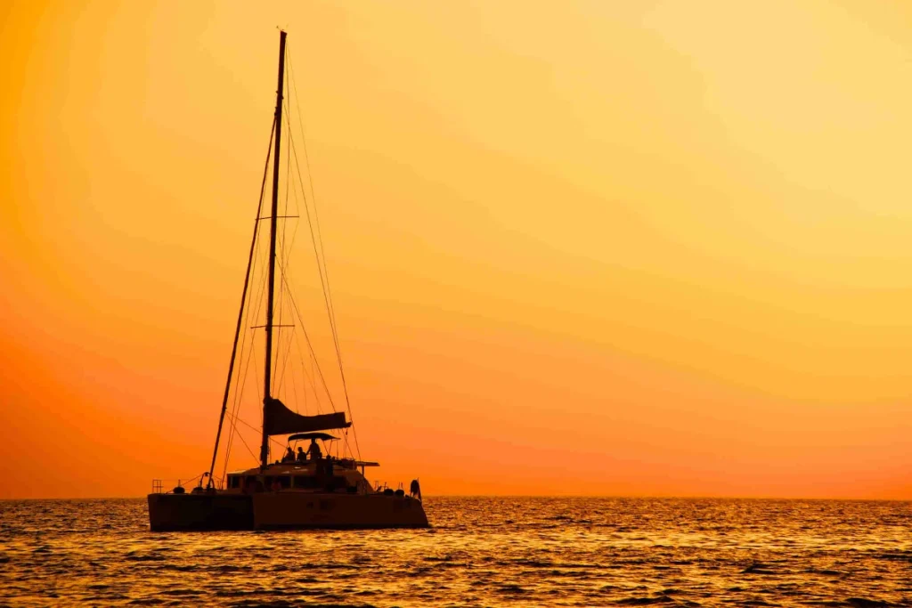 Catamaran sailing into the Pacific sunset on a guided sunset cruise from Playa Potrero, Costa Rica