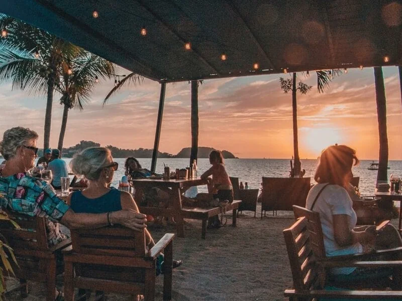 Diners watching the sunset over the Pacific from a beachfront restaurant in Playa Potrero, Costa Rica