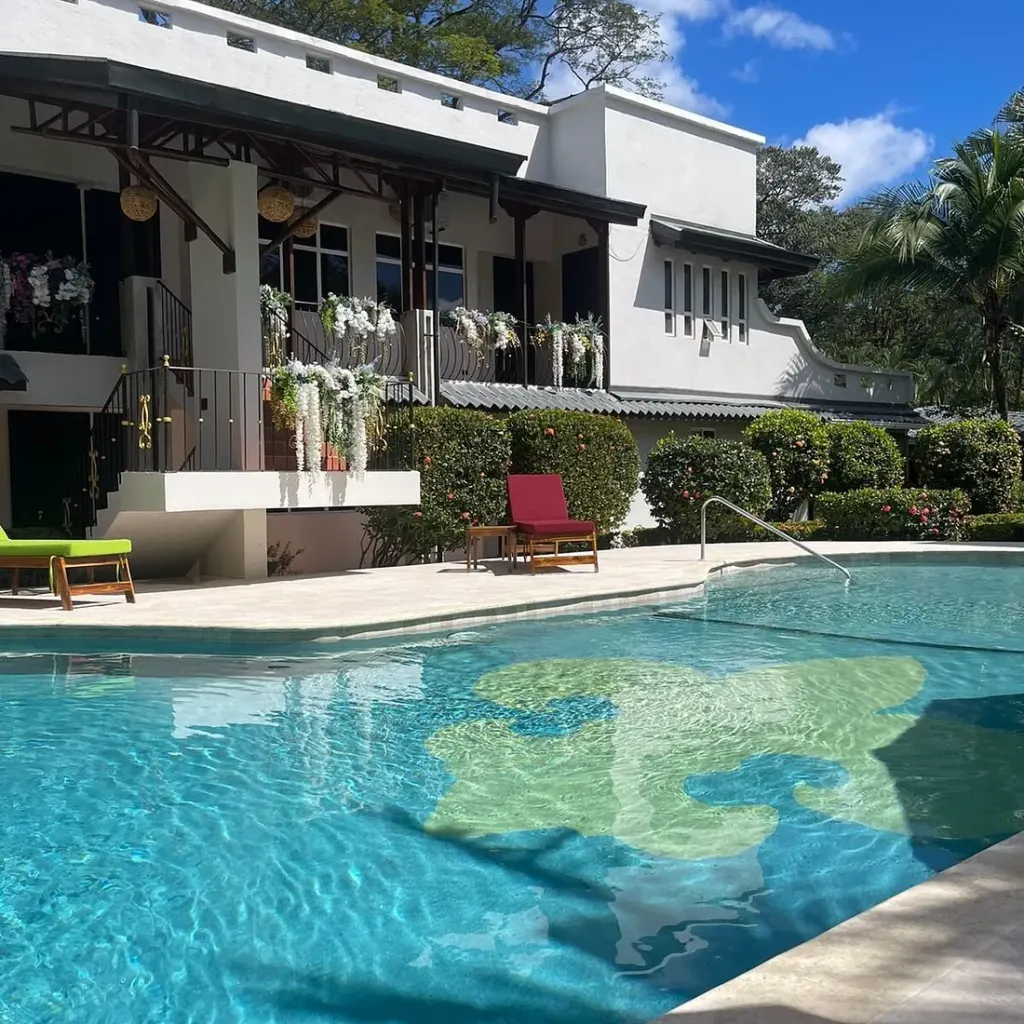 The pool and flower-draped balcony at Parti Gras Hotel, a short walk from the beach in Playa Potrero, Costa Rica