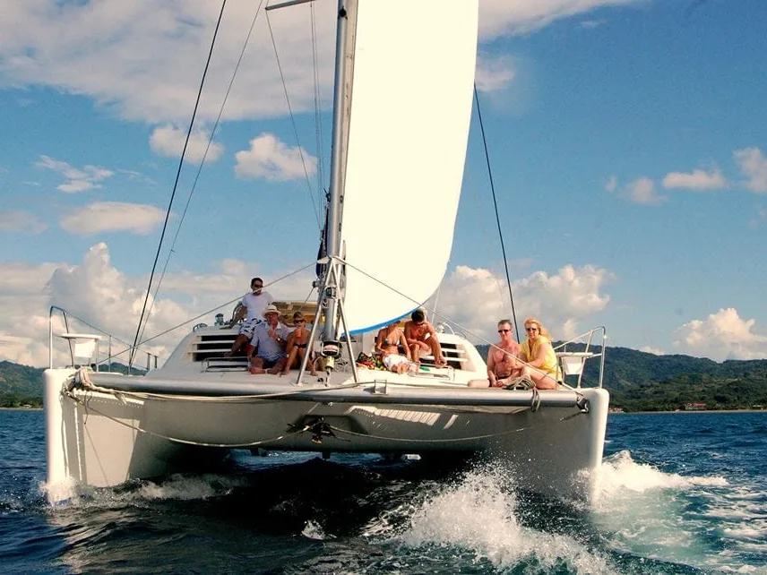 Guests enjoying a sunset catamaran cruise aboard the Panache, Guanacaste