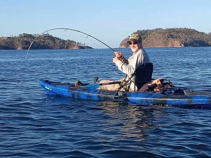 Angler fighting a fish while kayak fishing in Potrero Bay, Guanacaste, Costa Rica