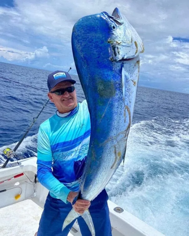 Angler holding a large mahi-mahi caught aboard Fish Tale II off Playa Flamingo, Costa Rica