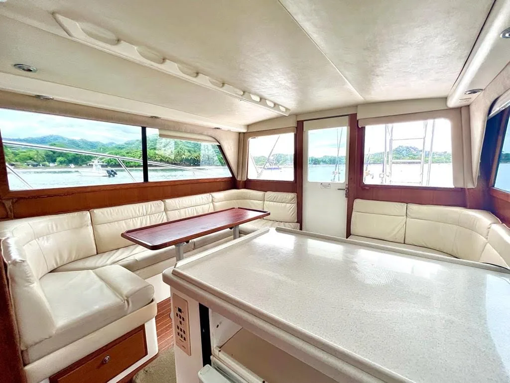 Fish Tale II salon interior with leather seating and harbor views through the windows