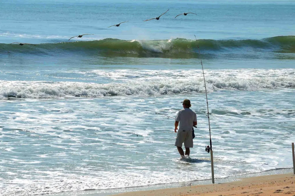 Angler surf casting from the beach at Playa Potrero, Guanacaste, Costa Rica