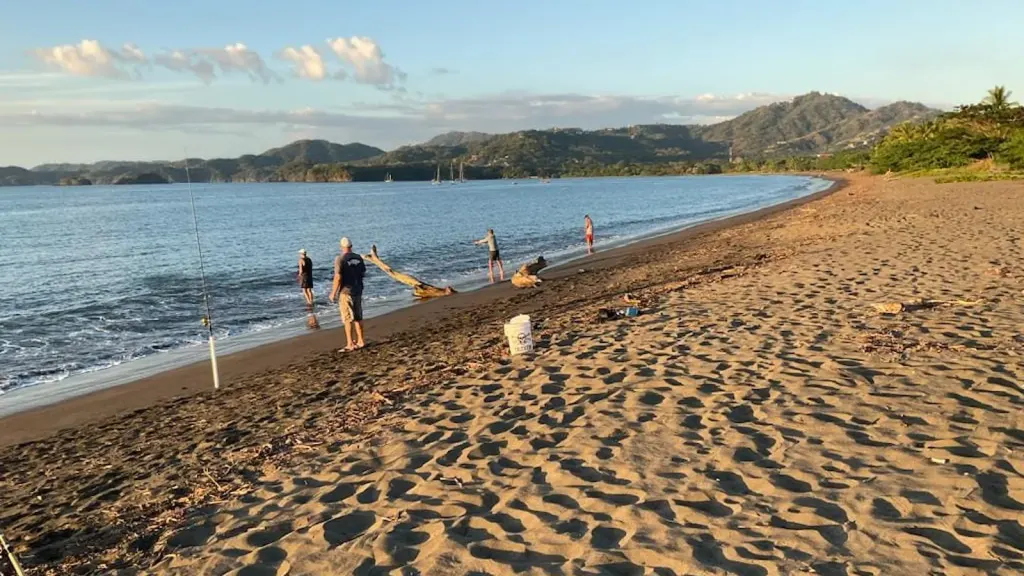 Group beach fishing at sunrise on Playa Potrero, Guanacaste, Costa Rica