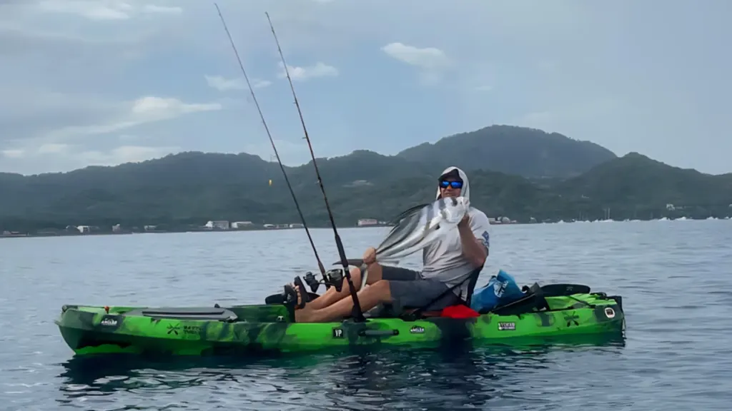 Angler with a roosterfish while kayak fishing in Potrero Bay, Guanacaste