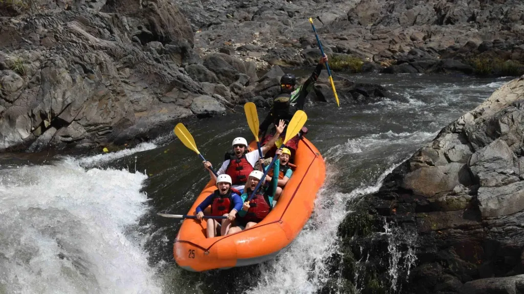 Raft going over a waterfall drop on a Tenorio River whitewater tour, Costa Rica