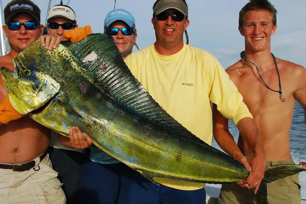 A group of five anglers holding up a large mahi-mahi caught offshore on a Fish Potrero charter in Guanacaste, Costa Rica