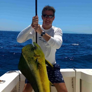 Fisherman holding his trophy Mahi Mahi off of the coast of Guanacaste, Costa Rica